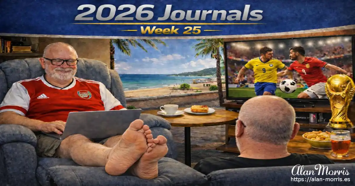 Alan Morris in an Arsenal shirt using a laptop, barefoot in a recliner, with a beach view and football on TV.