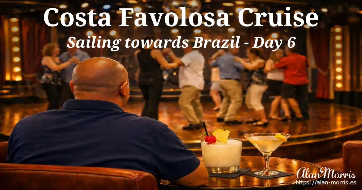 Alan Morris seated watching cruise‑ship dance lesson, Piña Colada and martini on table.