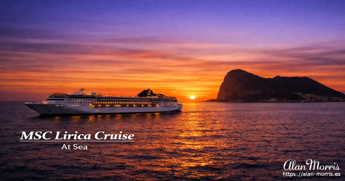 A cruise ship sailing at sunset with Gibraltar silhouetted behind.