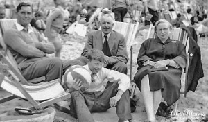 Family sitting on the beach.
